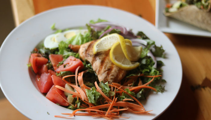 Garden salad topped with grilled salmon at Appleton Beer Factory brewery and brew pub restaurant bar Garden salad topped with grilled salmon at Appleton Beer Factory brewery and brew pub restaurant bar